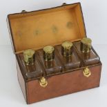 A set of four spirit flasks in fitted pigskin leather case,