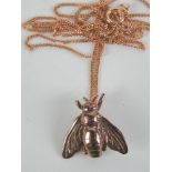 A rose metal pendant in the form of a Napoleonic Bee on a 9ct rose gold adjustable length fine link