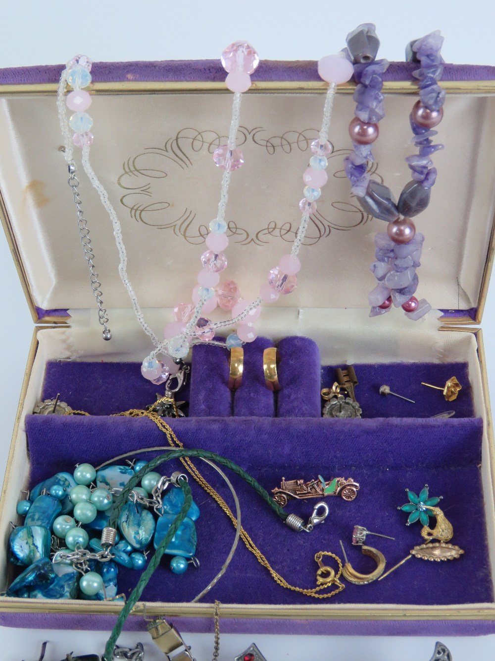 A quantity of assorted jewellery within purple velvet jewellery box includes some single silver - Image 2 of 4