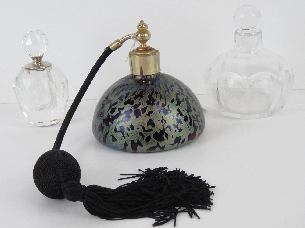 An art glass perfume bottle with atomiser together with two other glass perfume bottles.