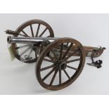 A deactivated table top 12 bore muzzle loading cannon and gun carriage, overall length approx 70cm,