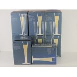 A set of thirty two (eight boxes of four) John Lewis glass champagne flutes, 'as new'.