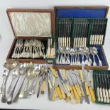 A large quantity of assorted silver plated and stainless steel cutlery including two wooden