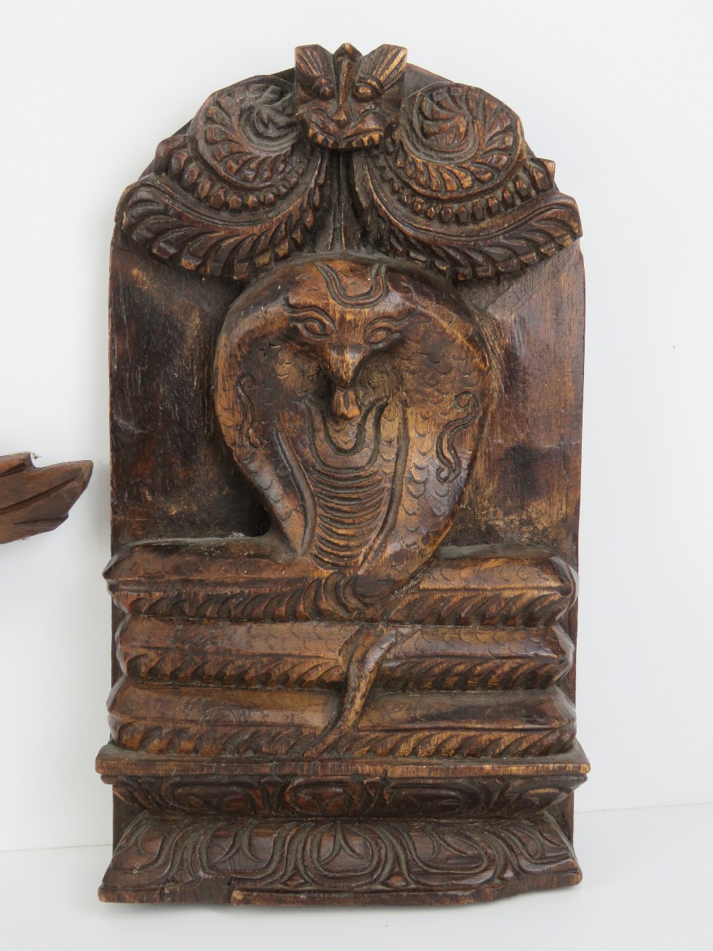 A carved Indo Asian wooden wall plaque having coiled serpent upon, 30 x 17cm high. - Image 2 of 3