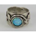 An Arts and Crafts black opal ring, indistict mark within,