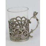 A HM silver and glass tot cup of delightful pierced foliate design with scrolling vine handle,