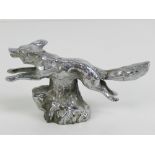 A silver plated car mascot bonnet ornament by Lejeune in the form of a running fox, with screw stud,