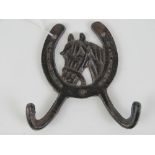 A double coat hook having horse head and