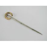 A horse shoe stock pin or tie pin, yello