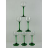 A set of six green stemmed hock glasses.