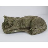 A precast stone garden figurine sleeping