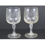 A pair of wine glasses having etched Cha