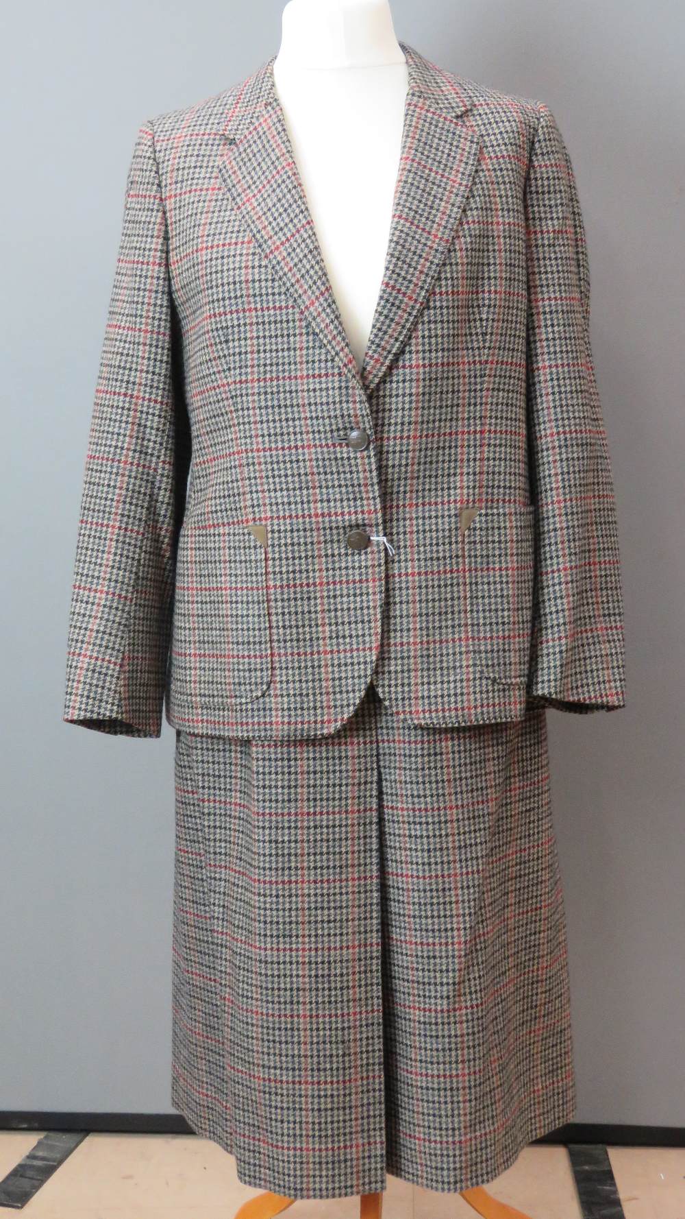 Burberry; A pure lambs wool ladies tweed suit jacket and skirt having suade elbow patches.