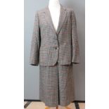 Burberry; A pure lambs wool ladies tweed suit jacket and skirt having suade elbow patches.