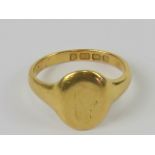 A 22ct gold signet ring, engraved crest worn almost removed, hallmarked Birmingham, 8.4g.