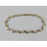 A 9ct white and yellow gold x-link bracelet, hallmarked 375, 19cm in length, 4.7g.