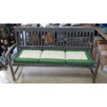 A wooden garden bench with associated three-seater cushion 158cm wide.
