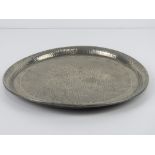 An Arts and Crafts English pewter dish having makers mark 'W & Co', 26.5cm diameter.