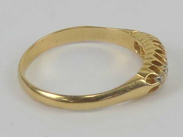 An 18ct gold diamond ring having carved head set with five graduated round cut stones, - Image 2 of 3