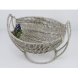 A handcrafted wirework hammock style fruit basket having label upon. 35cm wide.