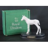 Royal Doulton 'Adventure' white foal on wooden plinth, 15cm high, with associated Royal Doulton box.