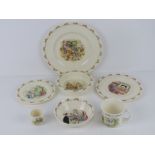Royal Doulton Bunnykins; a set of three graduated plates together with a bowl, a baby bowl,