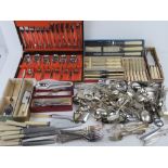 A large quantity of assorted cutlery including silver plated dessert forks,