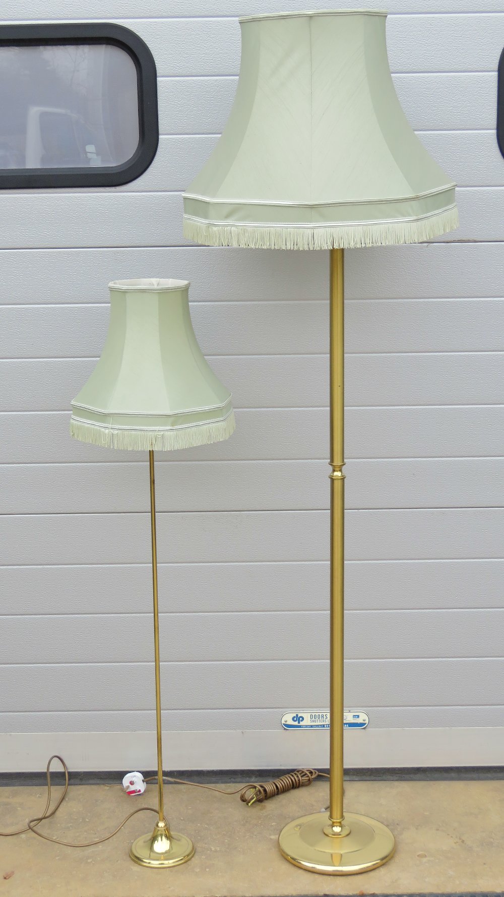 A contemporary brass stemmed standard lamp with frilled silk shade over,