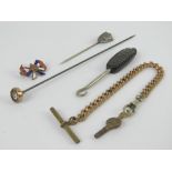 A 'Whitby' jet handled button hook, together with a hat pin, a white metal sheild shaped tie pin,