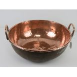 A large copper balti style pan, 40cm dia with twin handles.