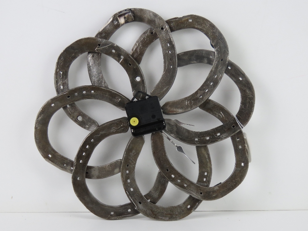 A wall clock formed from eight horseshoes and having central quartz movement, slightly a/f, - Image 2 of 2