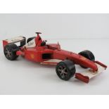 A decorative model Marlboro Ferrari F1 racing car having rotating wheels and measuring 43cm in