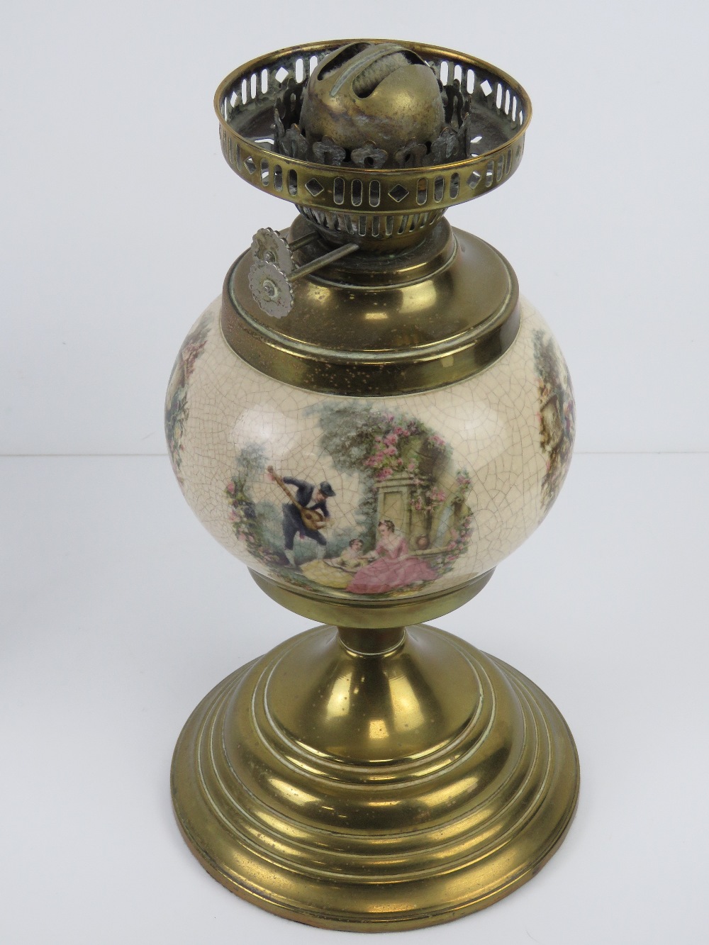 A brass oil lamp having ceramic reservoir with continental figural garden scenes upon, - Image 3 of 3