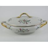 A French lidded turn having white ground with delicate pink and blue floral decoration upon,