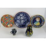 A quantity of brightly coloured decorative hand painted platters, together with two similar pots.