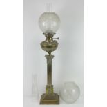 A brass oil lamp having classical shaped column upon stepped base, with glass shade and chimney,
