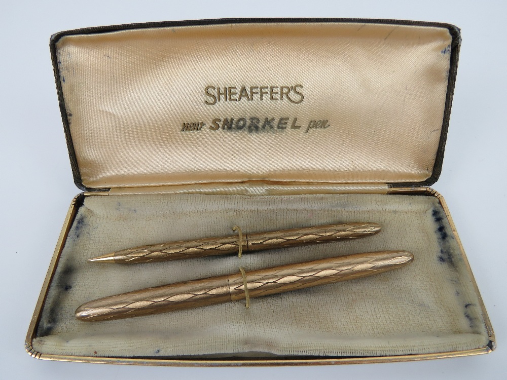 A Sheaffer's 'new snorkel pen set' in box being fountain pen and propelling pencil, slightly a/f.