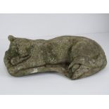 A precast stone garden figurine sleeping cat, 40cm in length.