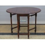 A c1930s oak drop leaf gate leg table 61 x 94cm extended.