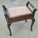 A mahogany piano stool c1930s, lid lifting to reveal music compartment within.