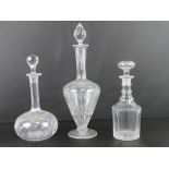A Bohemian shaped cut glass decanter of urn form over footed base, standing 38cm high.