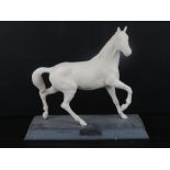 A white Beswick horse on stand, name plate deficient, 25cm high.