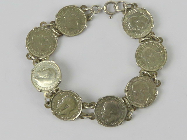 A 925 silver bracelet set with eight threepence coins 1917 - 194(0?), 19.5cm in length, 19.3g.