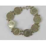 A 925 silver bracelet set with eight threepence coins 1917 - 194(0?), 19.5cm in length, 19.3g.