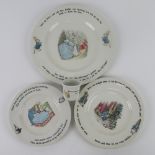 Peter Rabbit by Wedgwood; three graduated plates together with an egg cup.