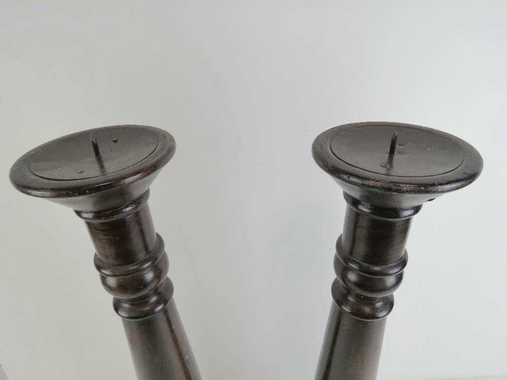 A pair of large turned wooden candlesticks, each 56.5cm high not inc spike. - Image 2 of 2