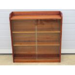 A glazed sliding door bookshelf in the style of Minty 90 x 23 x 94cm.