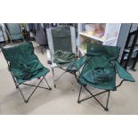 Three green canvas fishing or camping chairs.