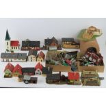 A quantity of Triang Hornby model railway trackside buildings together with cars, signs, fencing,