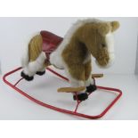 A rocking horse by Nylena having leatherette saddle and having been known as Sherbert for the past